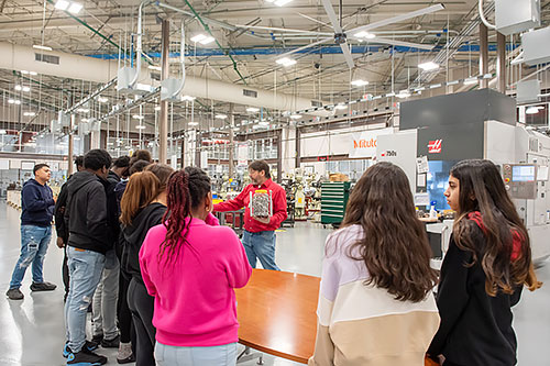 A group of middle school students get a tour of the Center for Advanced Manufacturing.